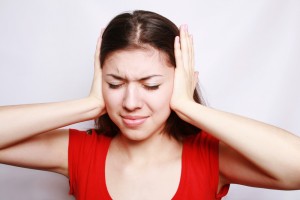 Girl Covering Ears with Hands | Shutterstock.com